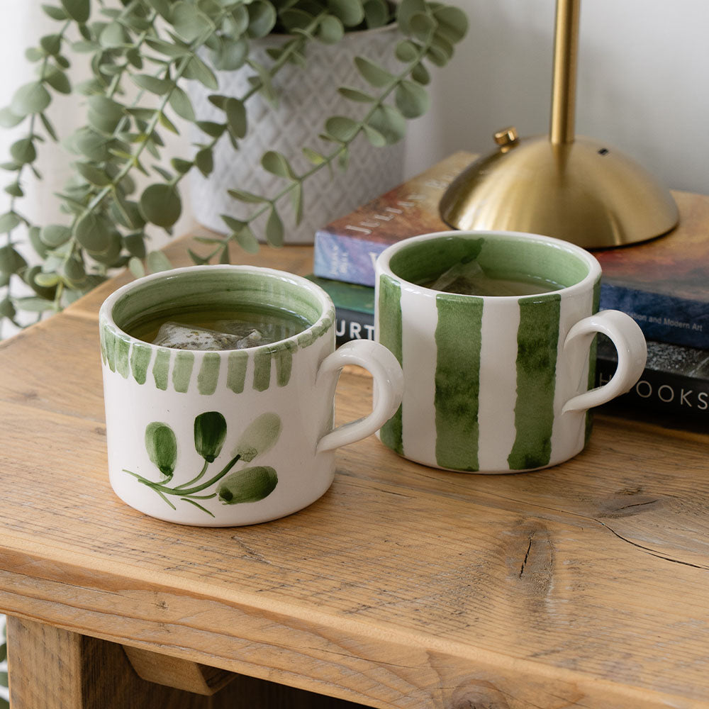 Selbrae House Ceramic Mug set featuring green botanical designs on a wooden table