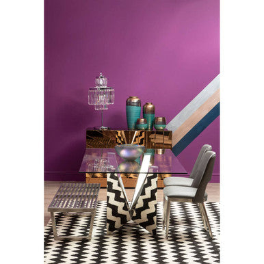 Orsina Ceramic Planter displayed on a stylish table against a vibrant purple wall