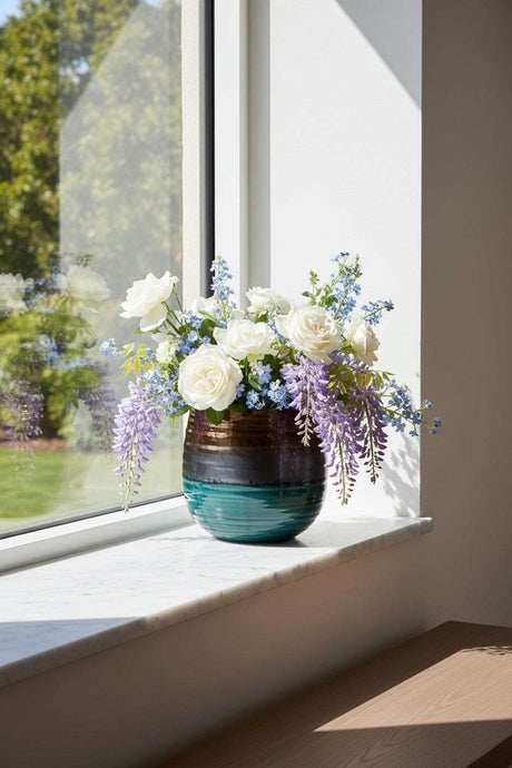 Orsina Ceramic Planter featuring beautiful flowers in a stylish design placed on a windowsill
