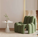 Stylish Nisu Home chair in green with a modern design next to a minimalist side table