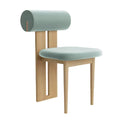 Modern Nisu Home Chair with a unique roll-back design and soft teal upholstery