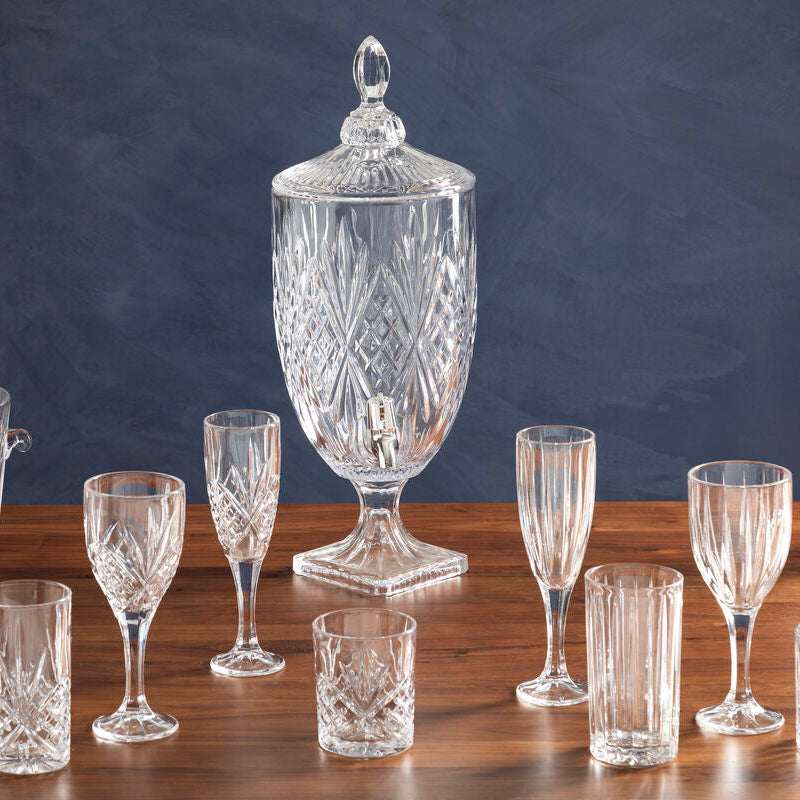 Elegant Orsina Champagne Flutes alongside a crystal beverage dispenser on a wooden table
