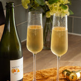 Elegant Selbrae House Champagne Flutes filled with sparkling vintage champagne on a wooden table