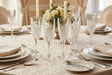 Elegant Orsina champagne glasses on a beautifully set dining table with floral arrangement