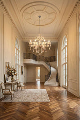 Elegant Orsina chandelier illuminating a grand foyer with a staircase and decorative details