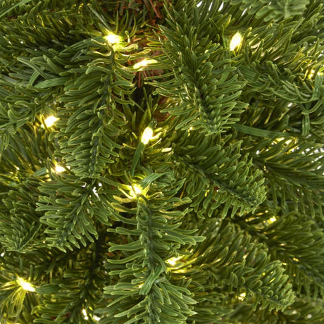 Close-up of a beautifully lit Christmas Tree adorned with soft white lights for festive decoration