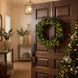 Shades 4 Seasons Christmas Wreath adorned with warm lights, ideal for festive door decorations
