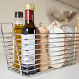 Orsina Chrome Caddy for storing kitchen essentials like oils and spices in a sleek metal design