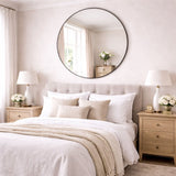 Stylish Circle Mirror above a bed in a beautifully designed bedroom setting