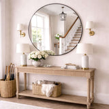 Jobu Home Circle Mirror elegantly displayed above a console table in a stylish entryway