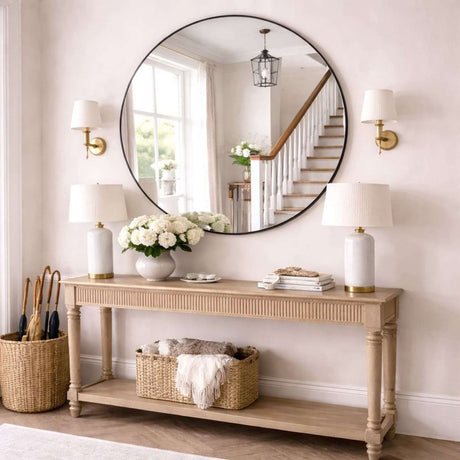 Jobu Home Circle Mirror elegantly displayed above a console table in a stylish entryway