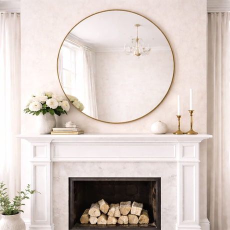 Elegant Circle Mirror with a Gold Frame above a White Fireplace and Elegant Decor