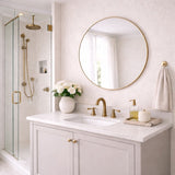 Elegant Circle Mirror by Jobu Home in a modern bathroom with a stylish shower and fresh flowers