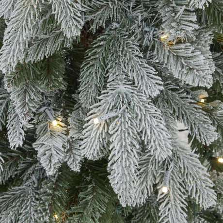 Frosted Christmas Tree branches adorned with warm fairy lights for festive decor