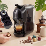 Wise Galleria Coffee Machine brewing espresso with a hand holding a coffee pod and coffee cups nearby