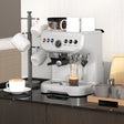 Wise Galleria Coffee Machine in silver brewing espresso with cups on a kitchen countertop