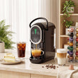 Wise Galleria Coffee Machine in black brewing espresso next to desserts and coffee cups