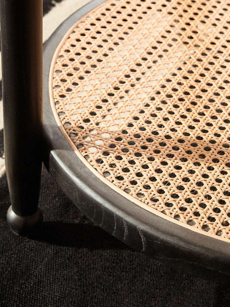 Orsina Coffee Table featuring a stylish woven rattan shelf and elegant dark wood base