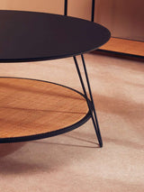 Orsina Coffee Table with a sleek black top and woven rattan shelf for stylish living room decor