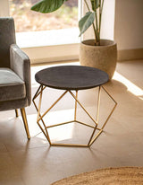Stylish Orsina Coffee Table with a round black top and geometric gold legs for modern living spaces