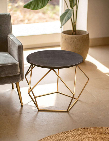 Stylish Orsina Coffee Table with a round black top and geometric gold legs for modern living spaces