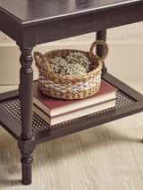 Orsina Coffee Table featuring a woven basket and stacked books on a stylish bottom shelf