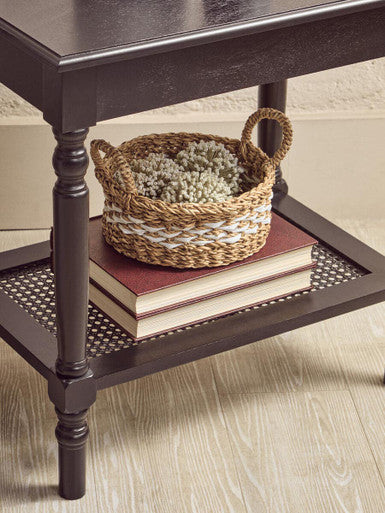 Orsina Coffee Table featuring a woven basket and stacked books on a stylish bottom shelf