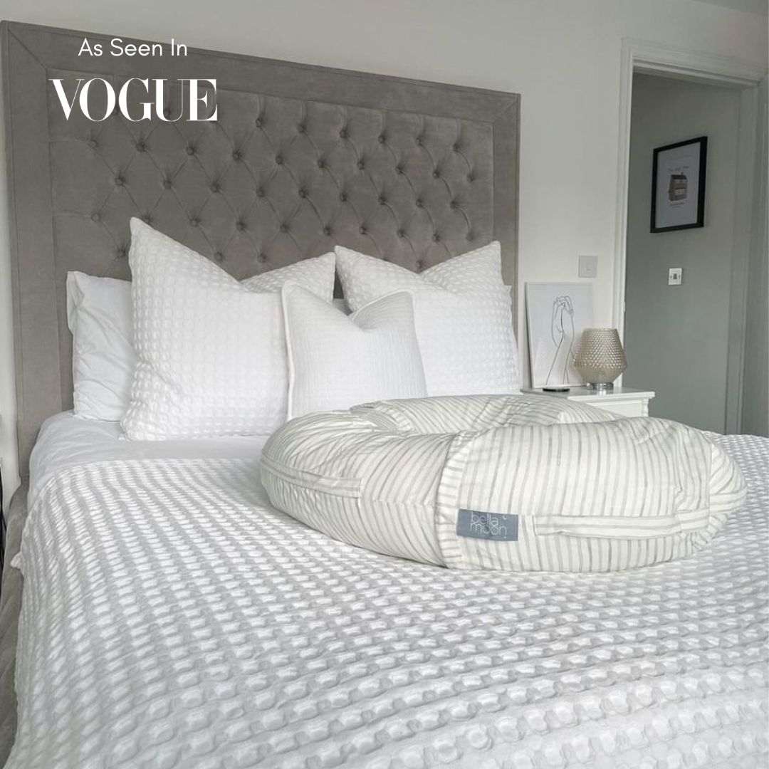 BellaMoon 3-in-1 Comfort Pillow in white resting on a textured bedding set in a stylish bedroom
