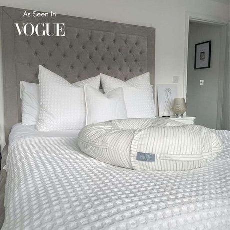 BellaMoon 3-in-1 Comfort Pillow in white resting on a textured bedding set in a stylish bedroom