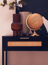 Orsina Console Table with Cane Drawer Detail and Decorative Vases and Globe on Top