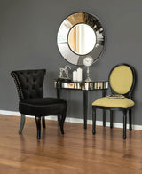 Elegant Orsina Console Table with a sleek mirrored finish and black legs, styled with decorative items