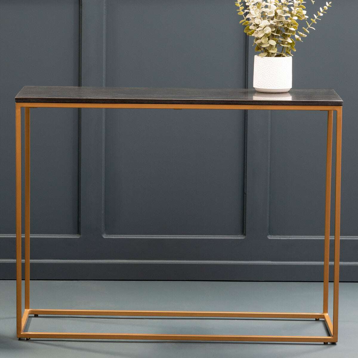 Orsina Console Table with a sleek black top and stylish gold metal frame, perfect for modern interiors
