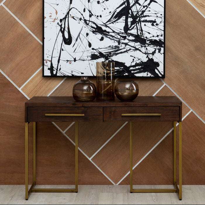 Stylish Orsina Console Table with two drawers and a sleek metal frame against a modern wall art backdrop