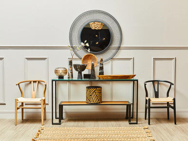 Orsina Console Table in Black with Decorative Bowls and Stylish Chairs in a Modern Living Room Setting