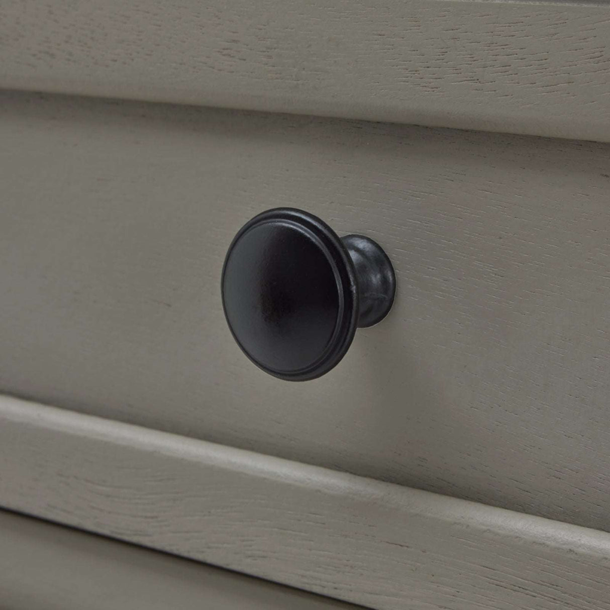 Close-up of a black knob on a beige console table from Shades 4 Seasons