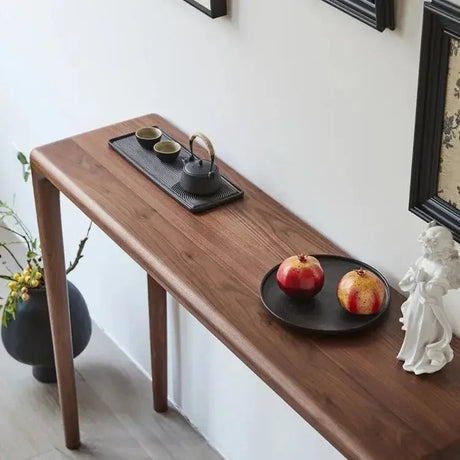 Nisu Home Console Table in wood finish, elegantly styled with decorative items and fruits
