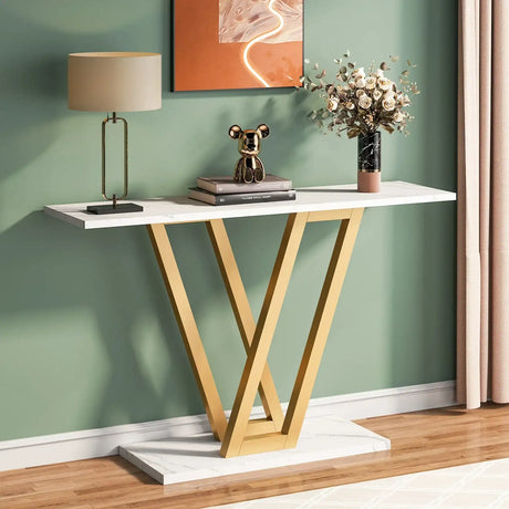 Klassyx Console Table with a sleek white top and gold V-shaped legs in an elegant living room setting
