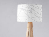 Modern geometric lampshade by Shadow Bright in white with grey patterns on a wooden lamp