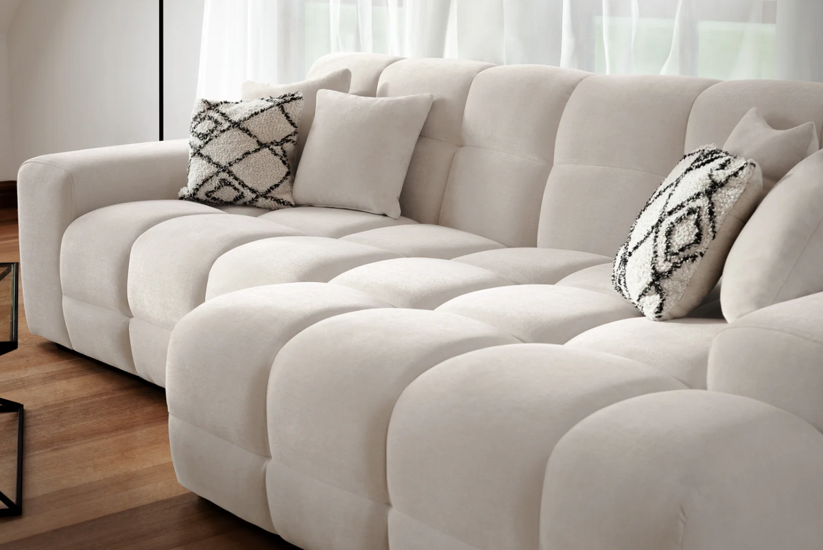 Modern Corner Sofa in Cream Fabric with Decorative Cushions for Relaxing Living Spaces