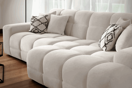 Modern Corner Sofa in Cream Fabric with Decorative Cushions for Relaxing Living Spaces