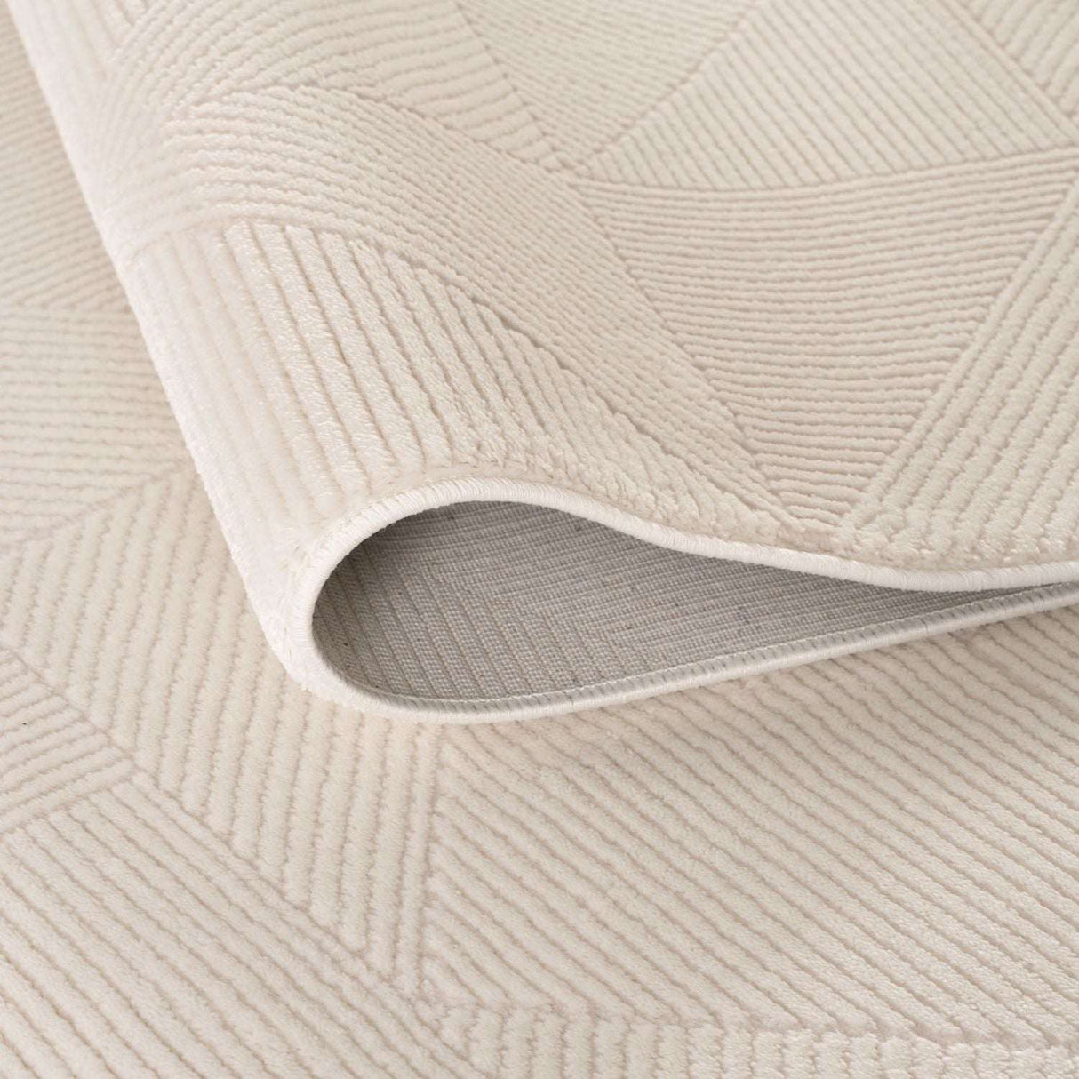 Soft cream rug with a textured geometric pattern, perfect for adding warmth to any room