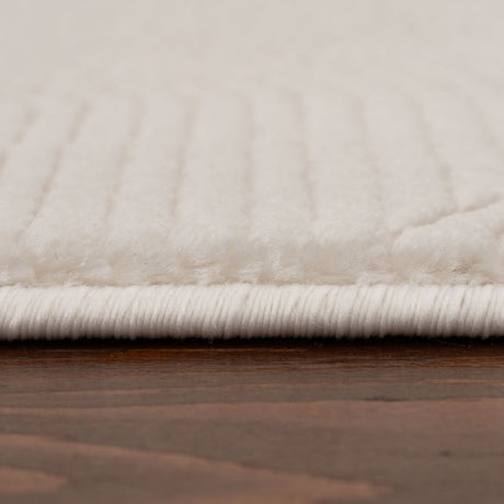 Close-up of a soft, textured cream rug with a subtle striped pattern