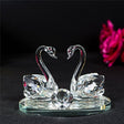 Elegant crystal glass swans figurine on a reflective base, perfect for home decoration