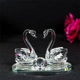 Elegant crystal glass swans figurine on a reflective base, perfect for home decoration