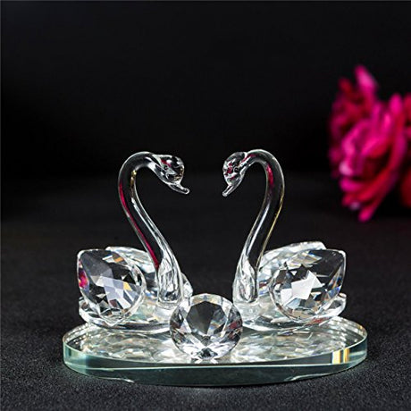 Elegant crystal glass swans figurine on a reflective base, perfect for home decoration