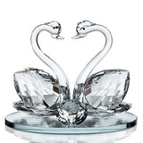 Elegant crystal glass swan figurine featuring two swans with a decorative base from London Boutique Lifestyle