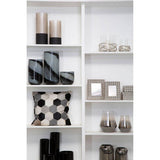 Orsina hexagonal patterned Cushion Cover displayed on a shelf with decorative vases and photo frames