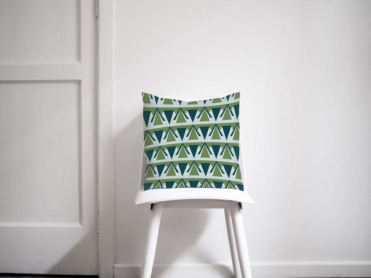 Green and blue patterned cushion placed on a white chair in a modern interior