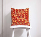 Shadow Bright Decorative Cushion with a vibrant red and orange circular pattern on a chair