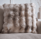 Faux fur cushion in soft beige tones perfect for adding texture to any living space